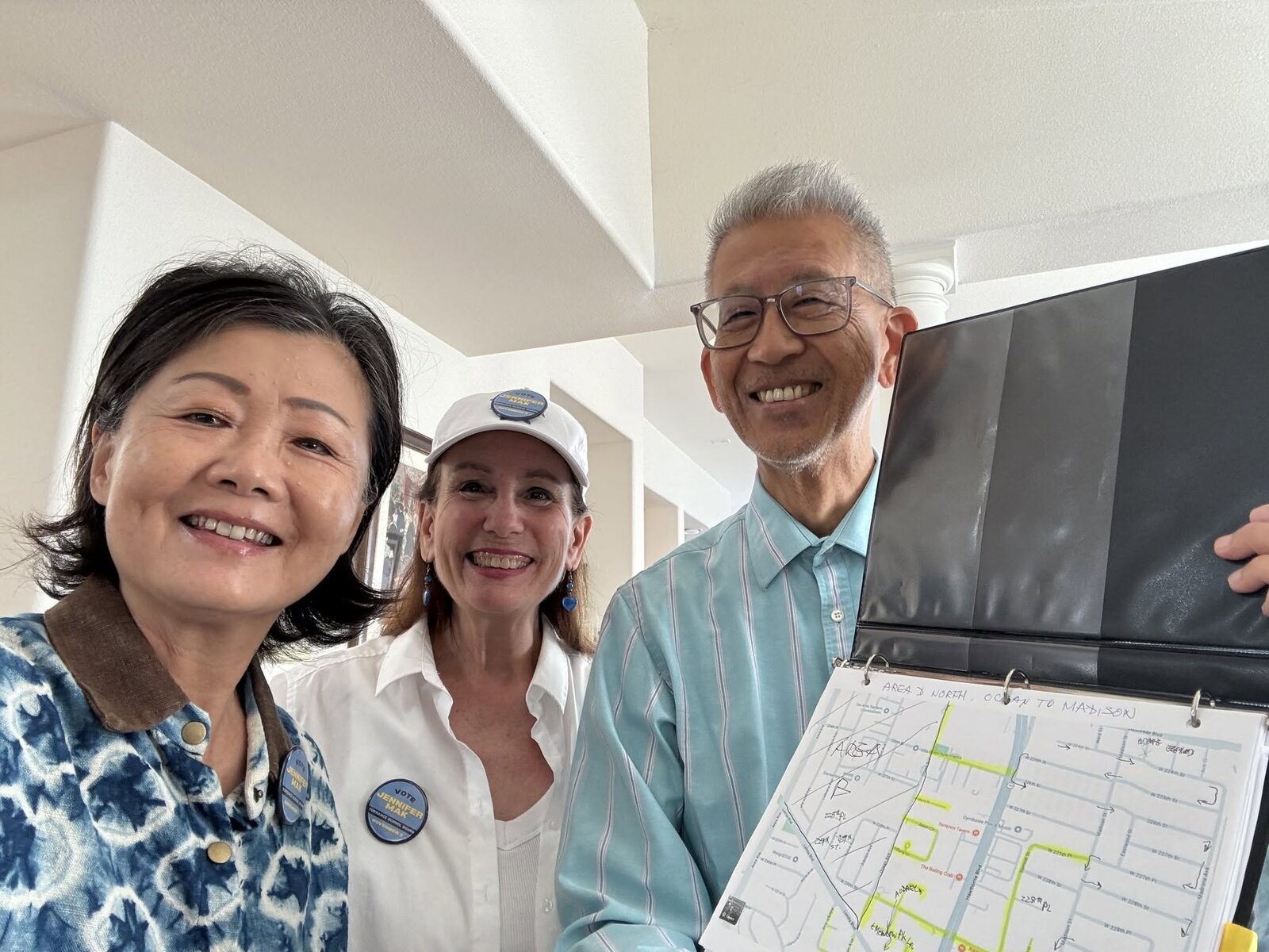 Jennifer Mak canvassing with two supporters and a neighborhood map