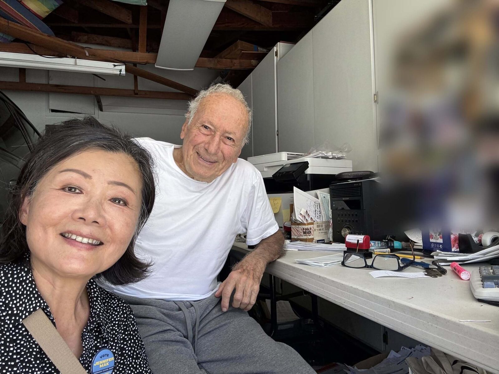 Jennifer Mak with Norman at the desk in his garage