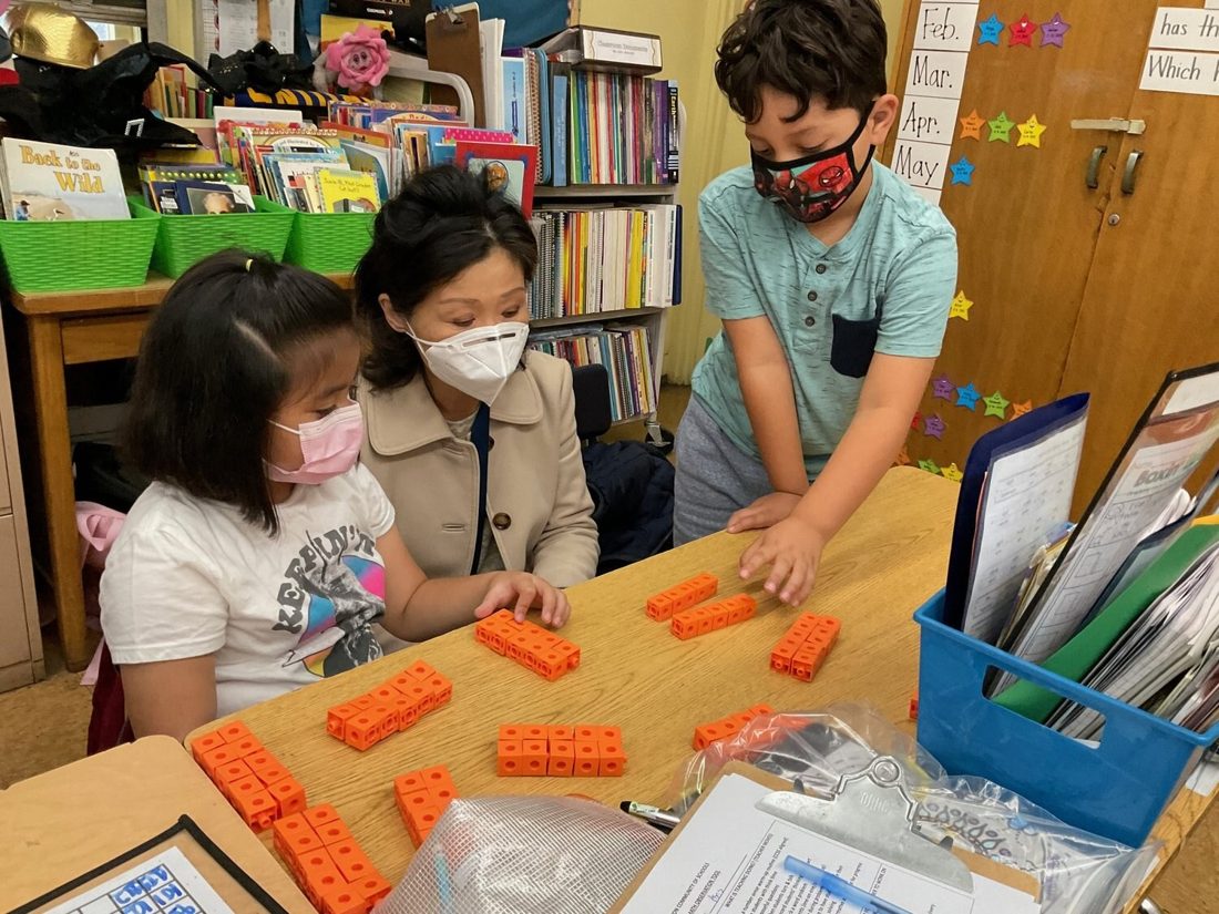 Jennifer working with students at a classroom table