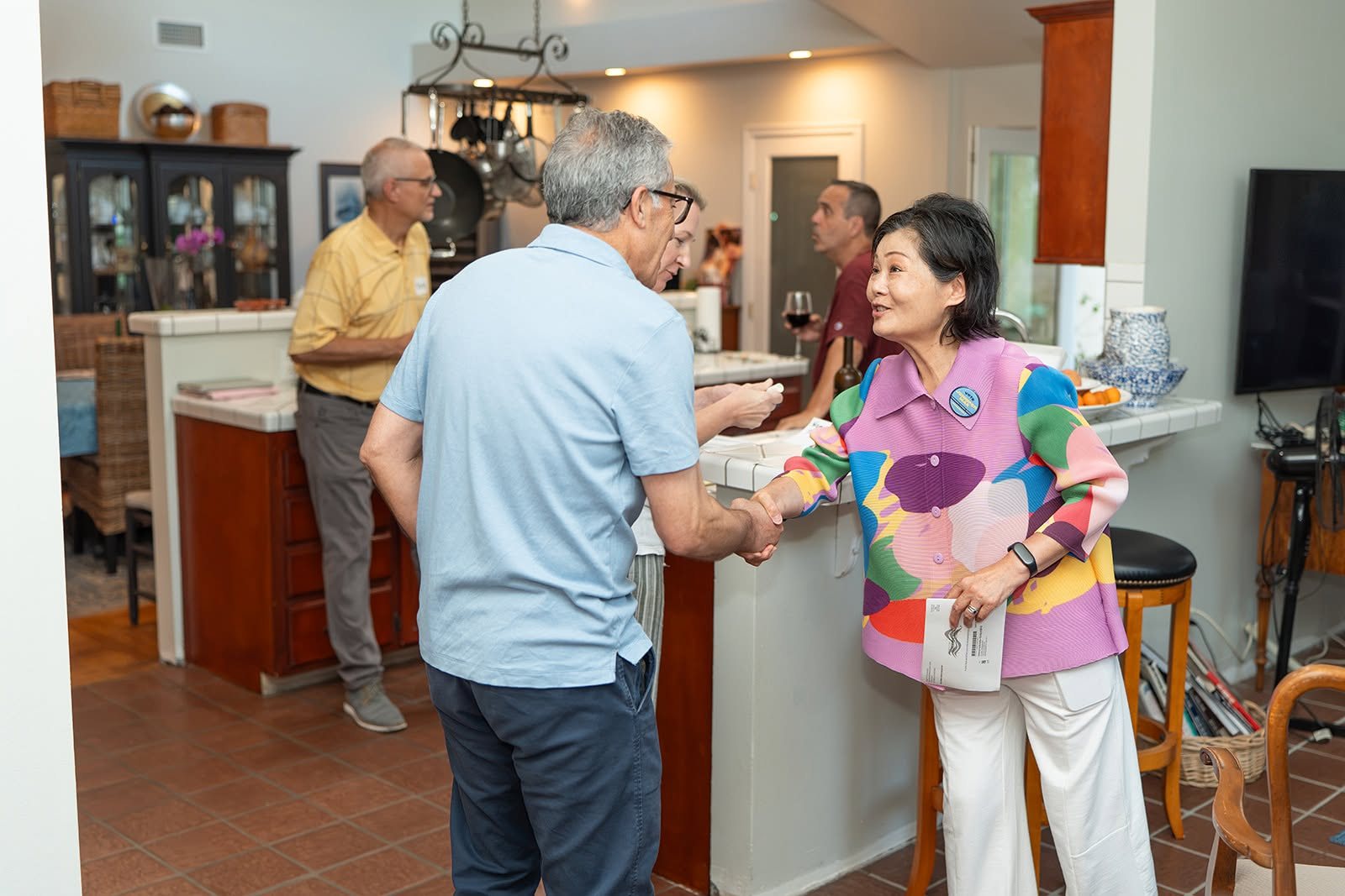 Jennifer greeting a guest in the kitchen