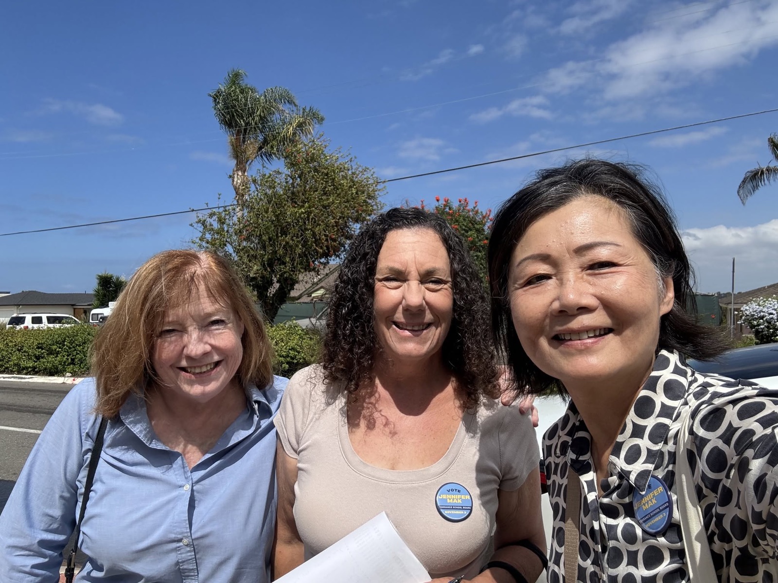 Jennifer Mak canvassing with two supporters wearing campaign buttons