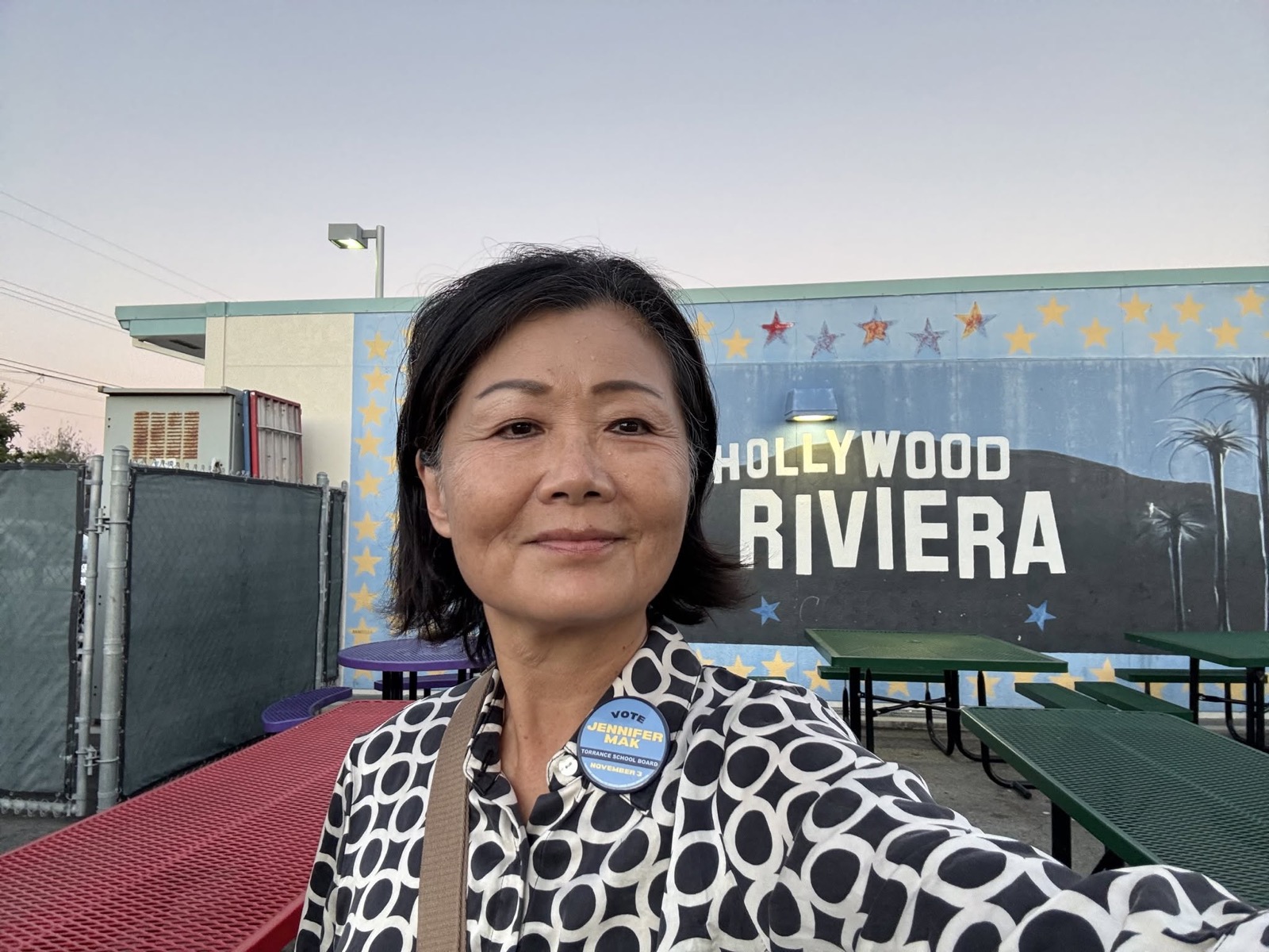 Jennifer Mak beside the Hollywood Riviera mural at Riviera Elementary