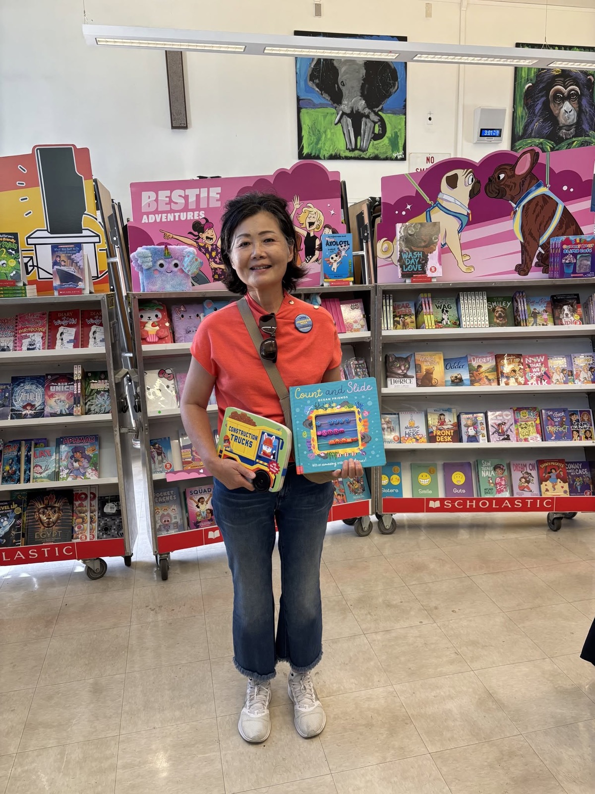 Jennifer Mak with two books from the Walteria Elementary book fair