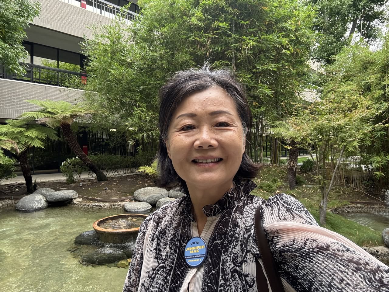 Jennifer Mak wearing her campaign button in the courtyard at the Torrance Area Chamber of Commerce