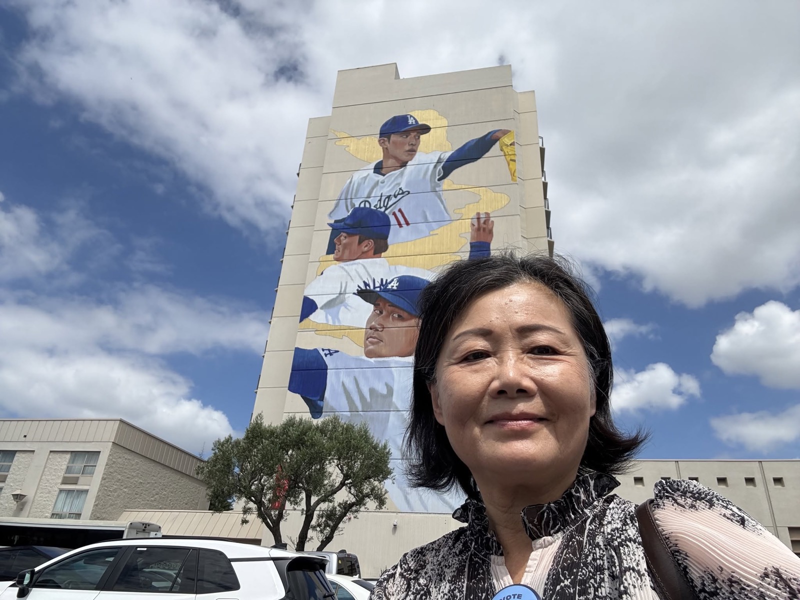 Jennifer Mak outside the luncheon, with the new Dodgers mural on the building behind her