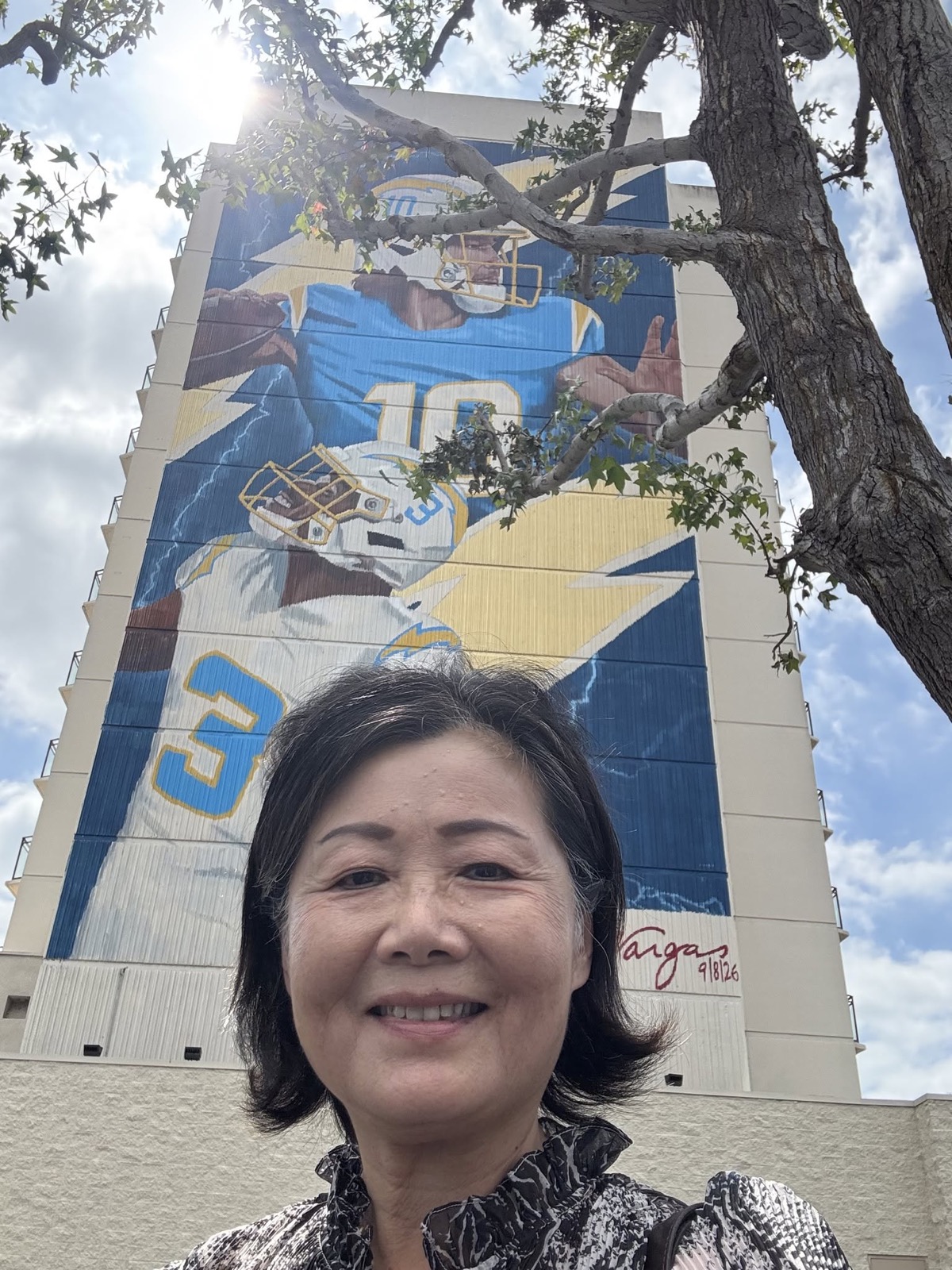 Jennifer Mak in front of the new Chargers mural in Torrance