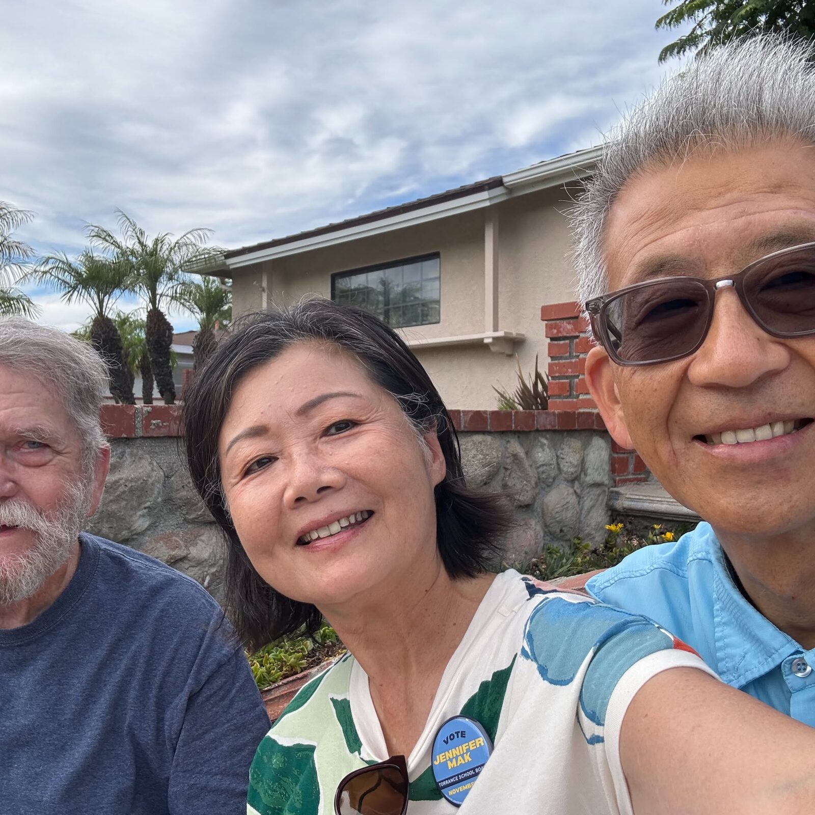 Jennifer Mak with neighbors outside a home