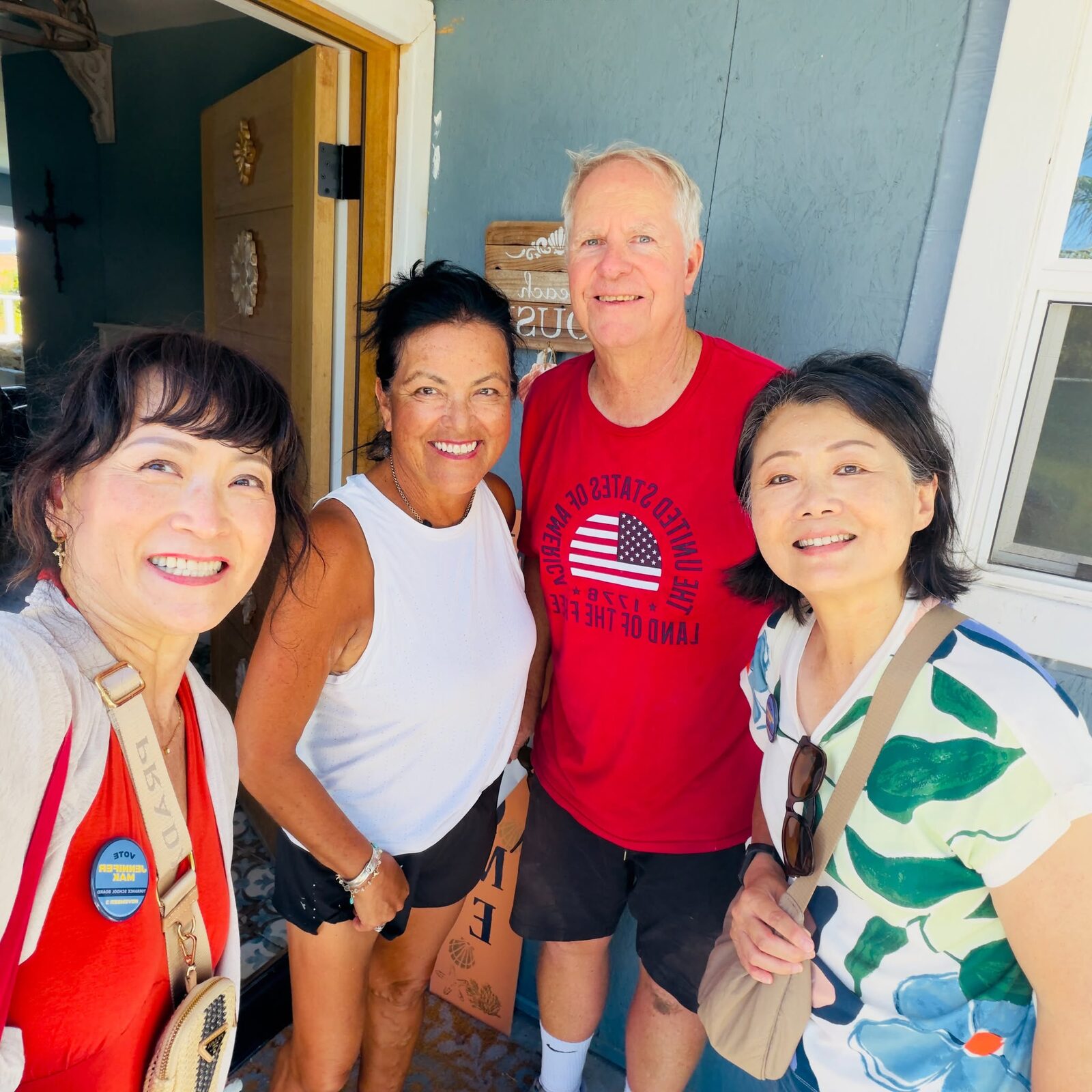 Jennifer Mak and fellow canvassers with residents at their front door