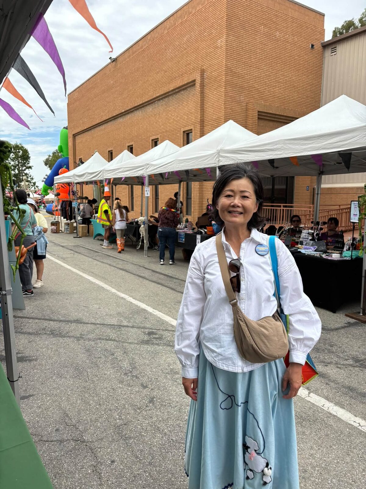 Jennifer Mak in a poodle skirt and campaign button at the ICAN Halloween Festival