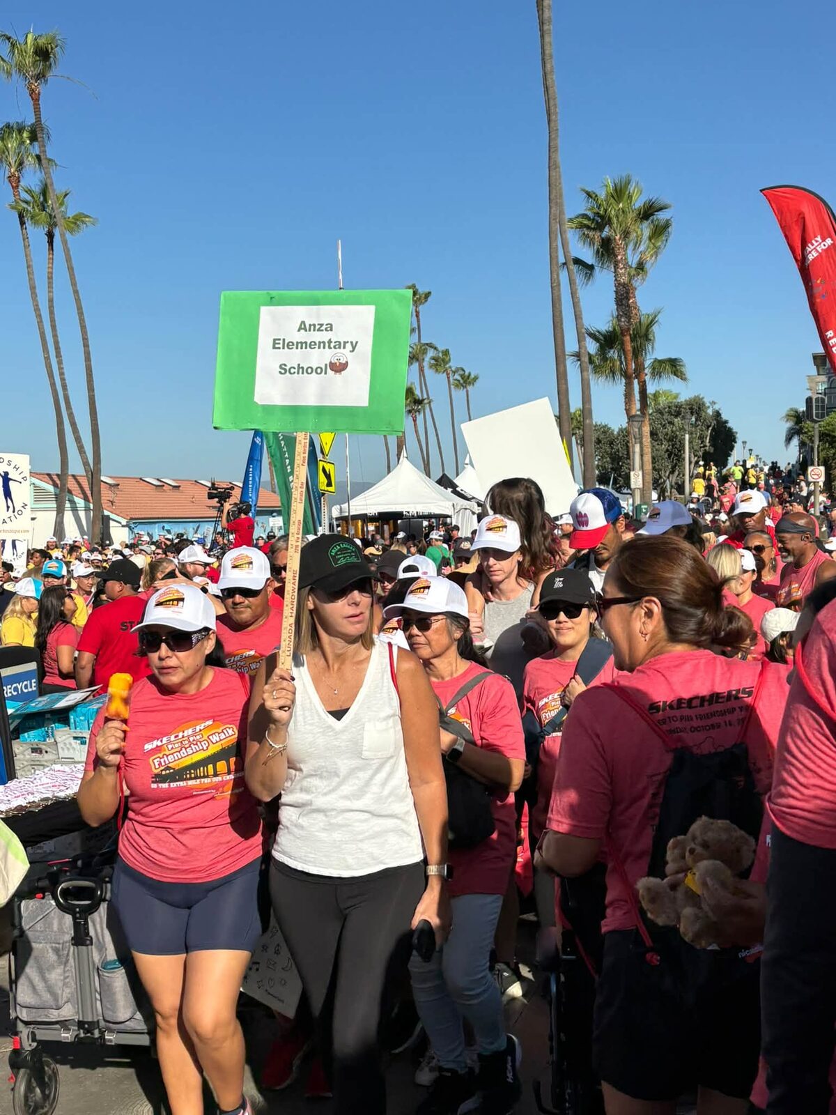 Walkers carrying an Anza Elementary School sign at the Skechers Walk