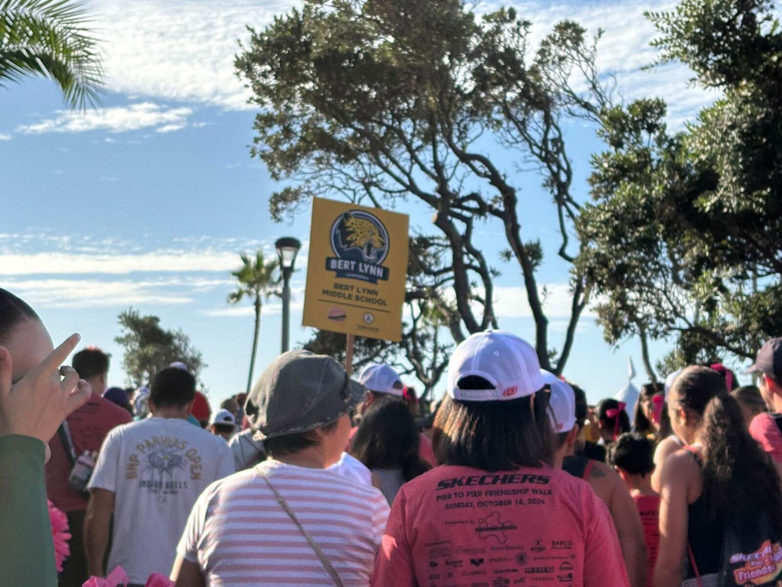 Walkers following a Bert Lynn Middle School sign