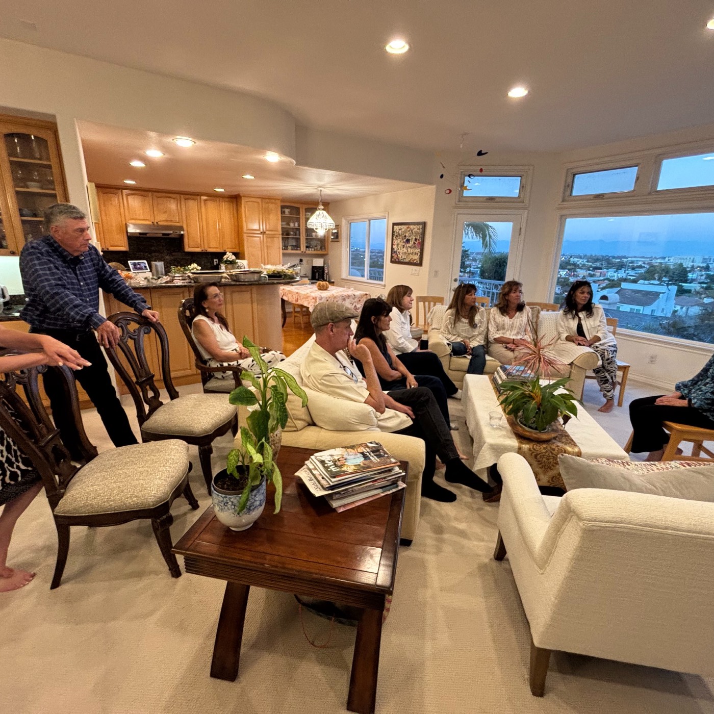 Neighbors gathered in a living room to meet Jennifer Mak