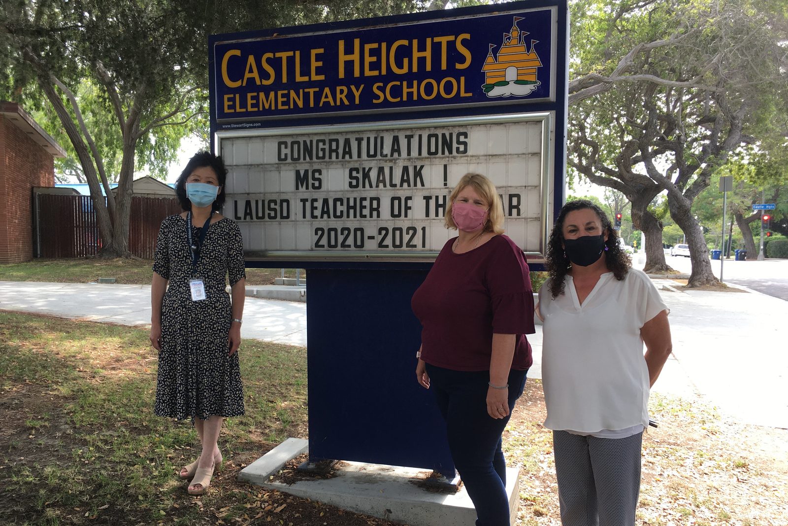Jennifer Mak with Telle Skalak and a colleague at the Castle Heights Elementary School sign: Congratulations Ms Skalak! LAUSD Teacher of the Year 2020-2021