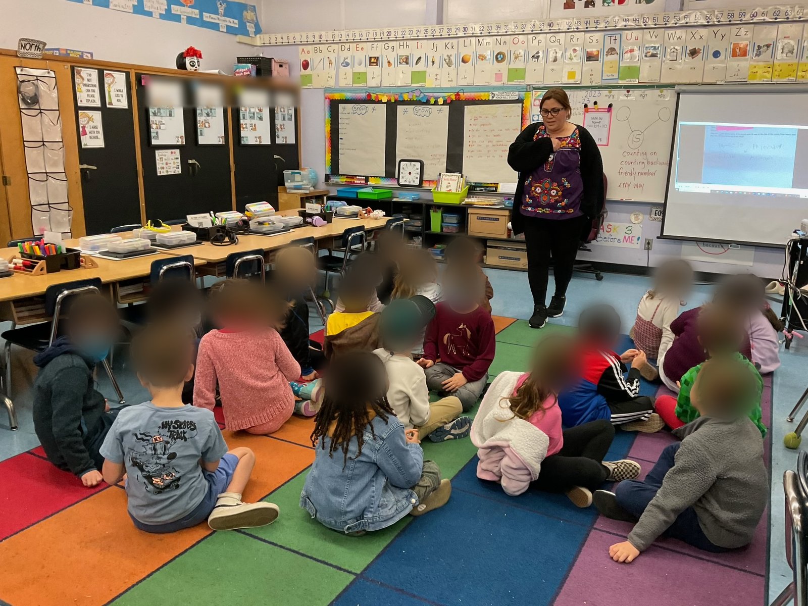Xochitl Becerra teaching her first graders on the rug in her Castle Heights Elementary classroom
